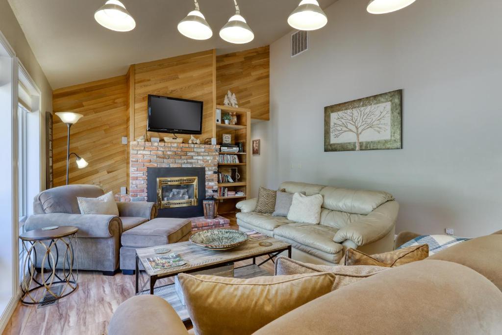 a living room with couches and a fireplace at 8 Dixie Mountain Lane in Sunriver