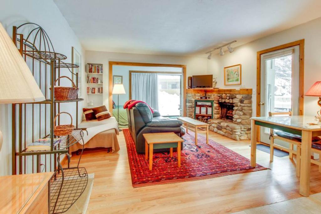 a living room with a couch a chair and a fireplace at Snow Run Studio in Ketchum