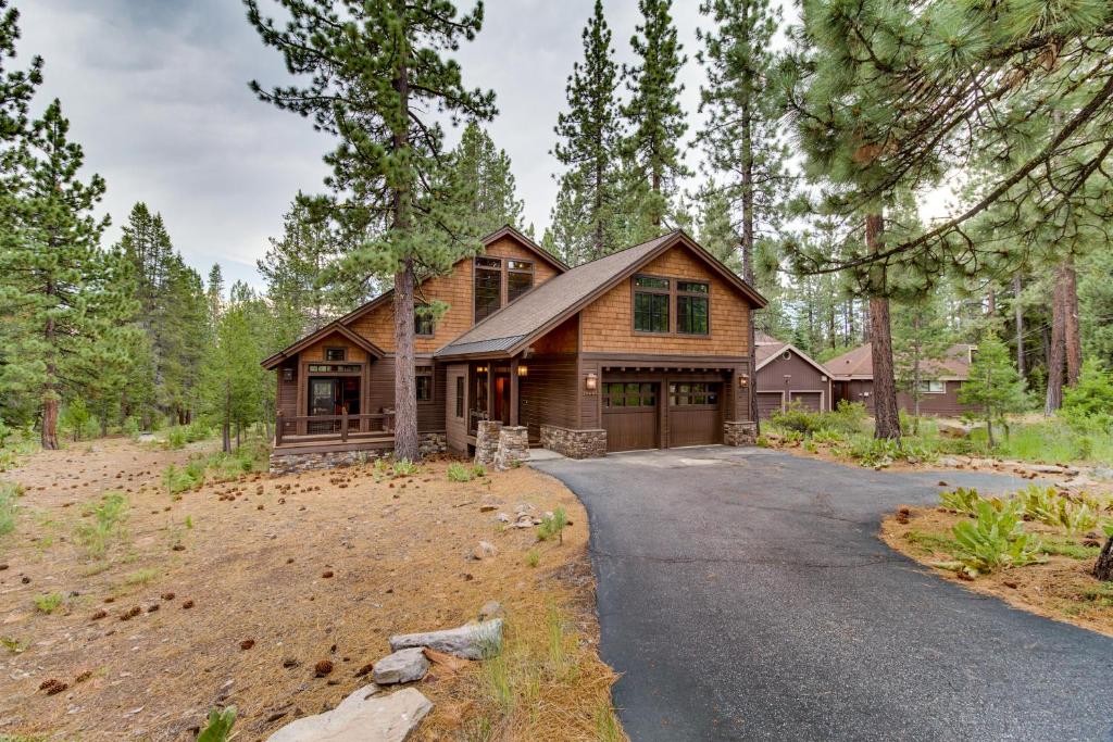a house in the woods with a driveway at The Great Escape in Truckee