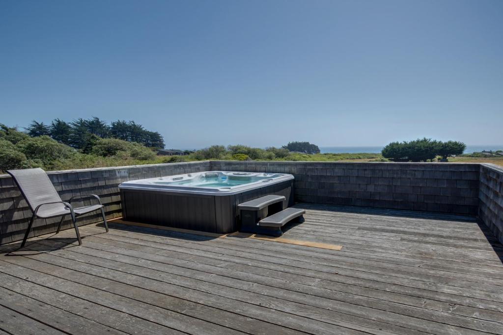 a deck with a hot tub on top of a house at Cadwalader House in Sea Ranch