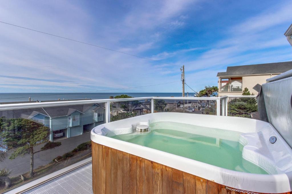 a hot tub on the balcony of a house at Harbor SeaShell in Lincoln City
