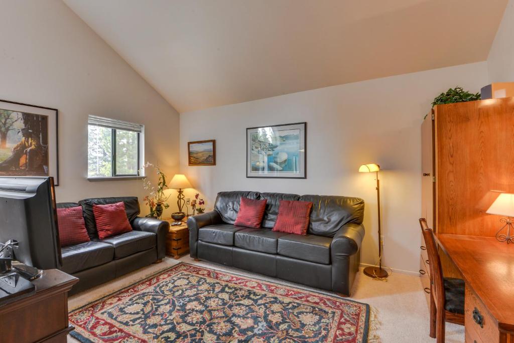 a living room with a couch and a tv at Powder Village G-1 | Discover Sunriver in Sunriver
