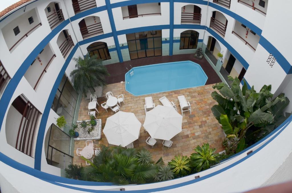 an overhead view of a building with a swimming pool at Bombinhas Palace Hotel in Bombinhas