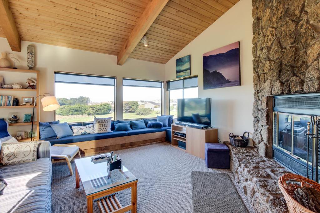 a living room with a couch and a fireplace at Prentiss Retreat in Sea Ranch