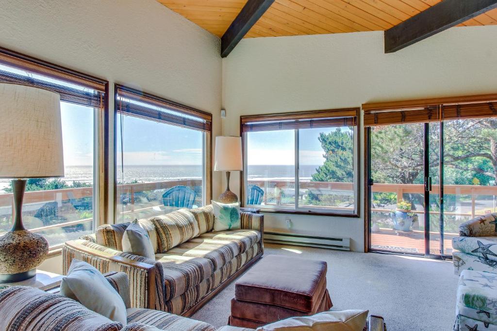 a living room with couches and large windows at Arrow Point in Newport