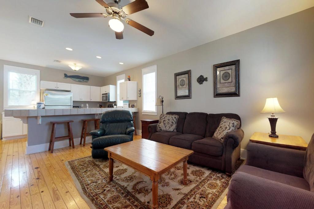 a living room with a couch and a table at Barefoot Cottages #B16 in Highland View