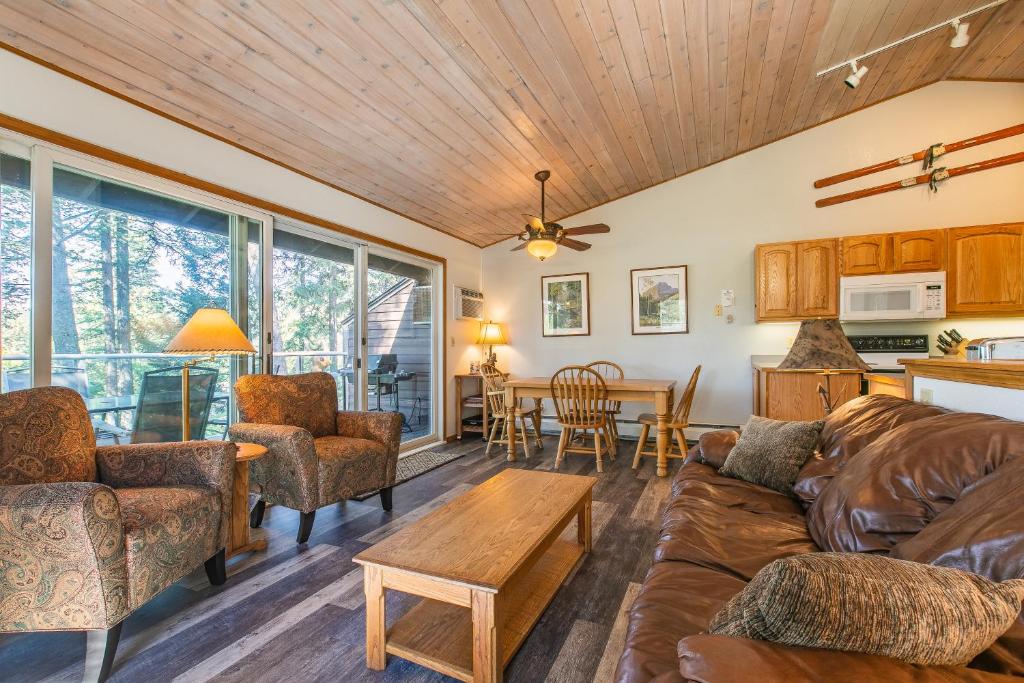 a living room with a couch and a table at Bay Point Hillside 15D in Whitefish