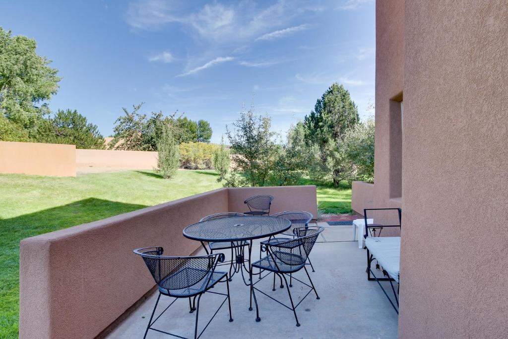 a patio with a table and chairs on a balcony at Solano Vallejo 3349 in Moab
