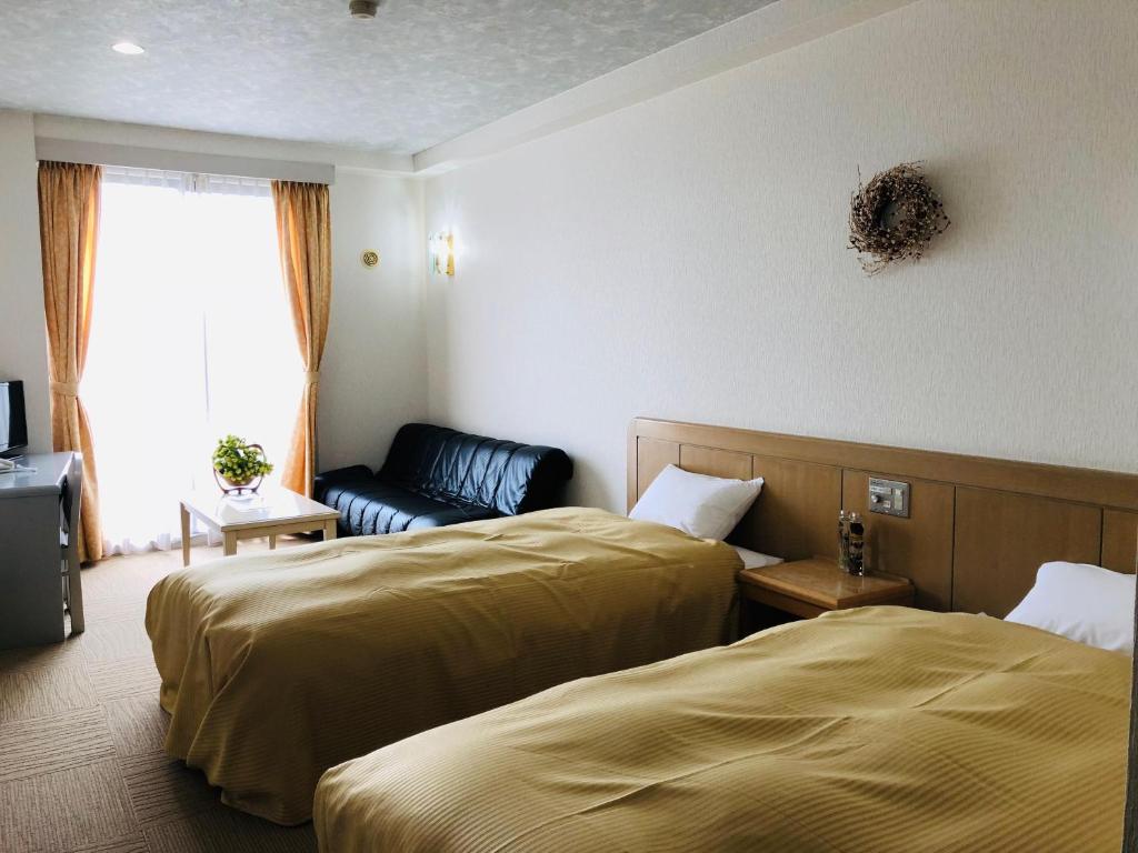 Postel nebo postele na pokoji v ubytování Hotel Belle-Cour Inomata