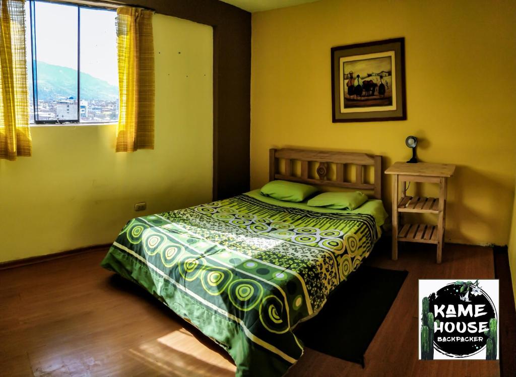 a bedroom with a bed and a window at Kame House hostel in Huaraz