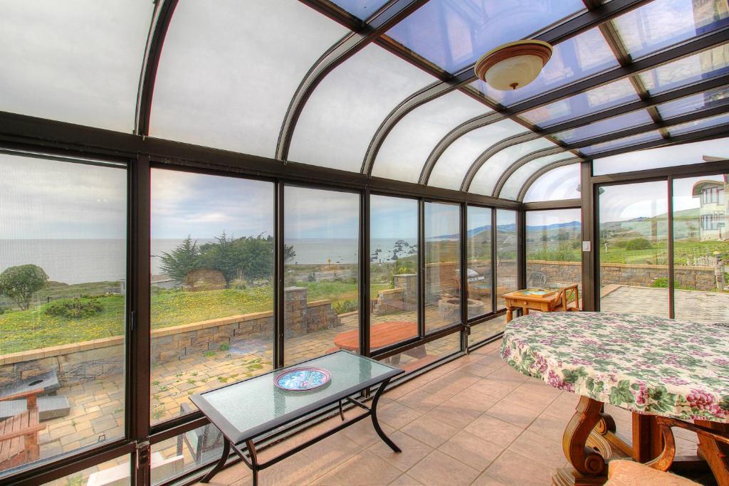 a bedroom with a view of the ocean through windows at Welcome to My View"" in Bridgehaven