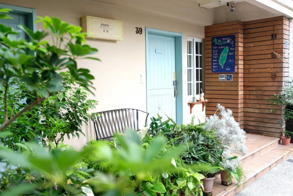 a front porch of a house with a blue door at Backpacker 41 Hostel - Kaohsiung in Kaohsiung
