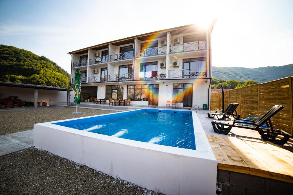 a house with a swimming pool in front of it at Vila La Faleza Dubova in Dubova