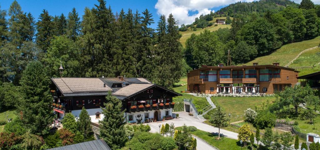 an aerial view of a house in the mountains at Der Erlhof Restaurant & Landhotel in Zell am See