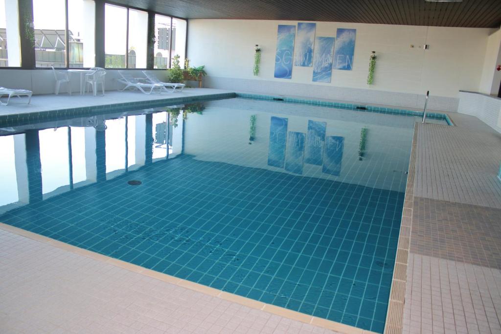 a swimming pool with a blue tile floor at Ferienwohnung Francois in Höchenschwand