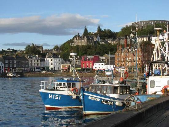 two boats docked at a dock in a harbor at Panoramic Harbour View Apartment in Oban