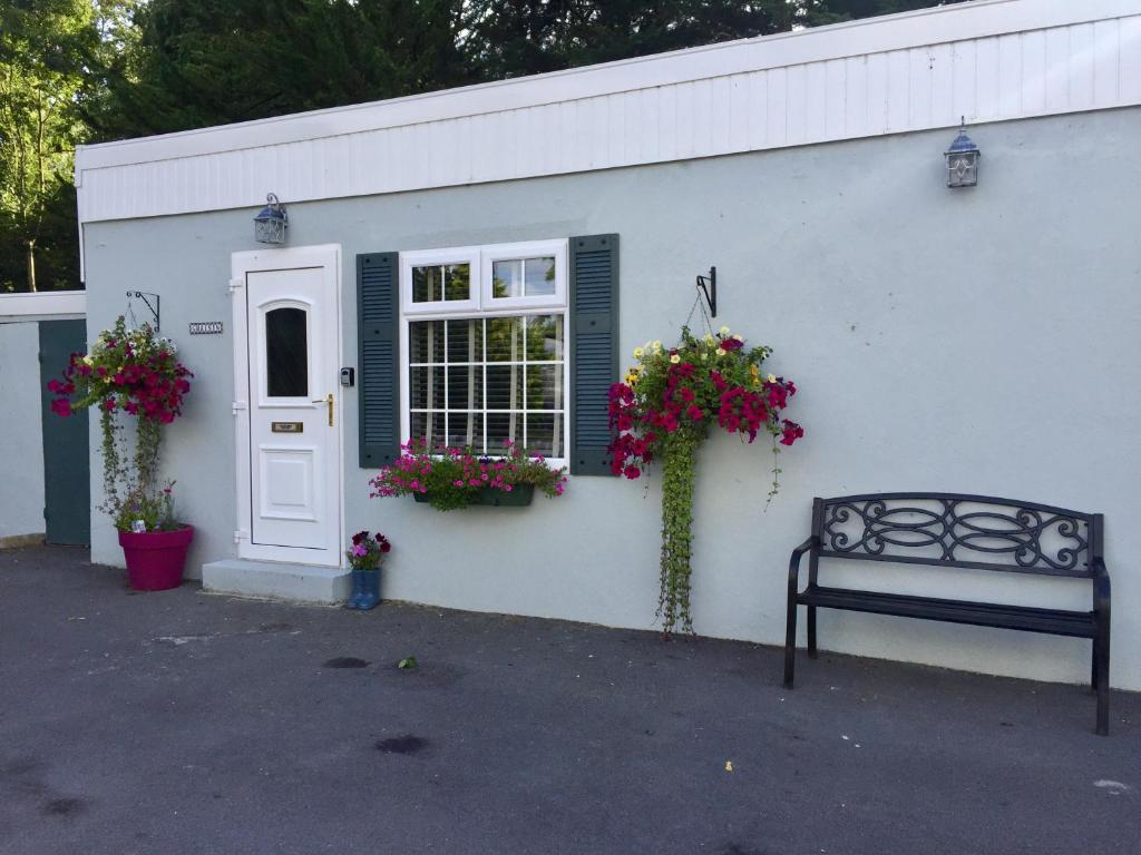 a white building with a window and a bench at Gráisín in Kilkenny