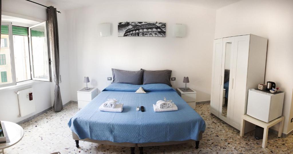 a bedroom with a bed and a desk at Ostiense District B&B in Rome