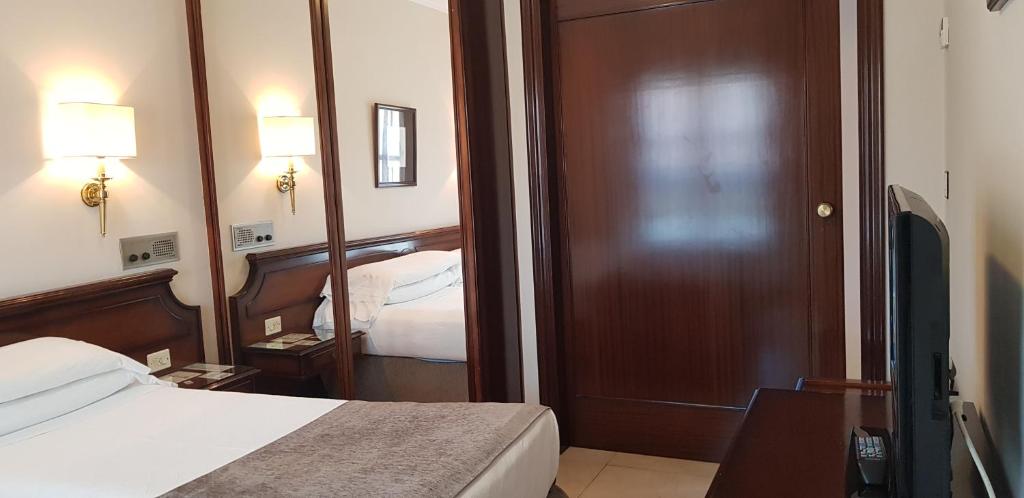 Postel nebo postele na pokoji v ubytování Gran Hotel Paraiso