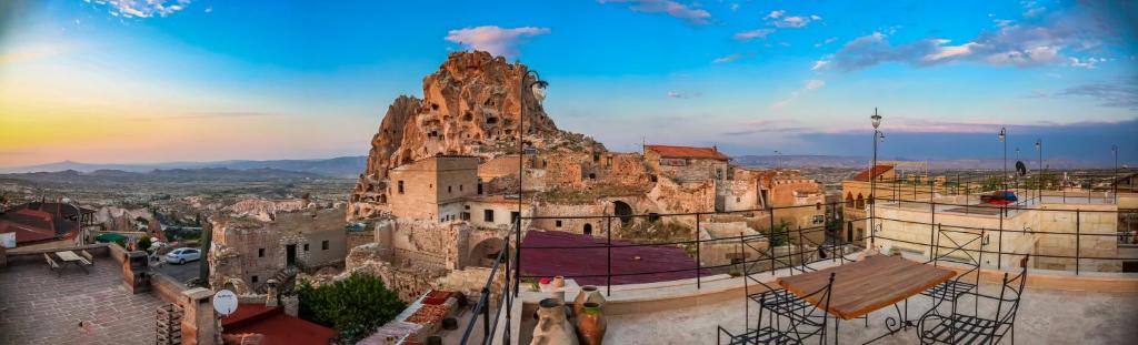 a view of a building with a mountain at ikarus Cappadocia Hotel in Uchisar