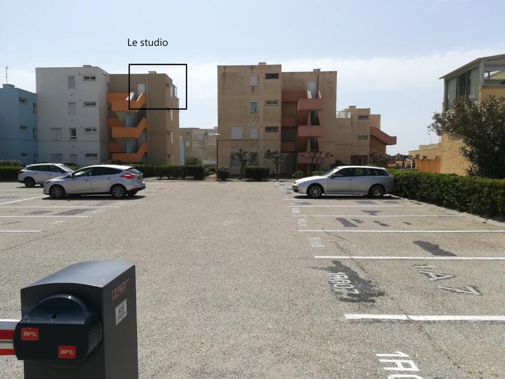a parking lot with several cars parked in it at Studio les pieds dans l'eau App n°7 in Le Barcarès