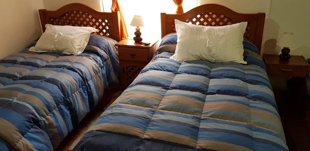Krevet ili kreveti u jedinici u okviru objekta Hostal Casa Amarilla San Vicente de Tagua Tagua