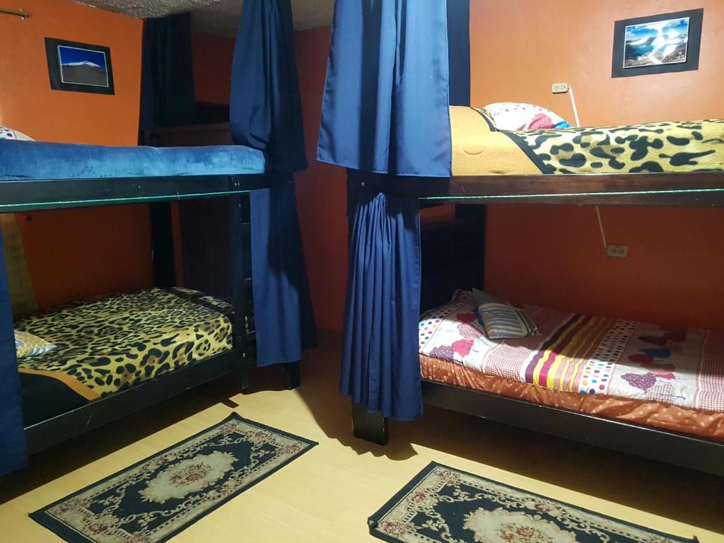 Postel nebo postele na pokoji v ubytování Hostal Sendero de Volcanes