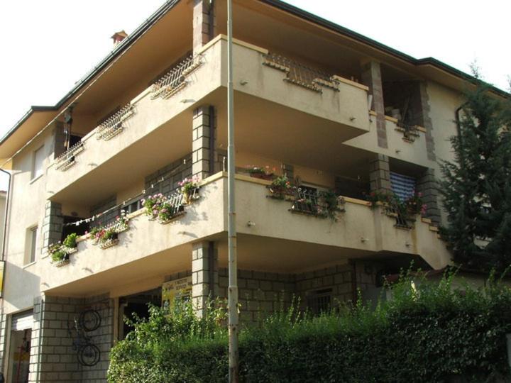 an apartment building with potted plants on the balconies at Pietro & Graziella in Sorgono