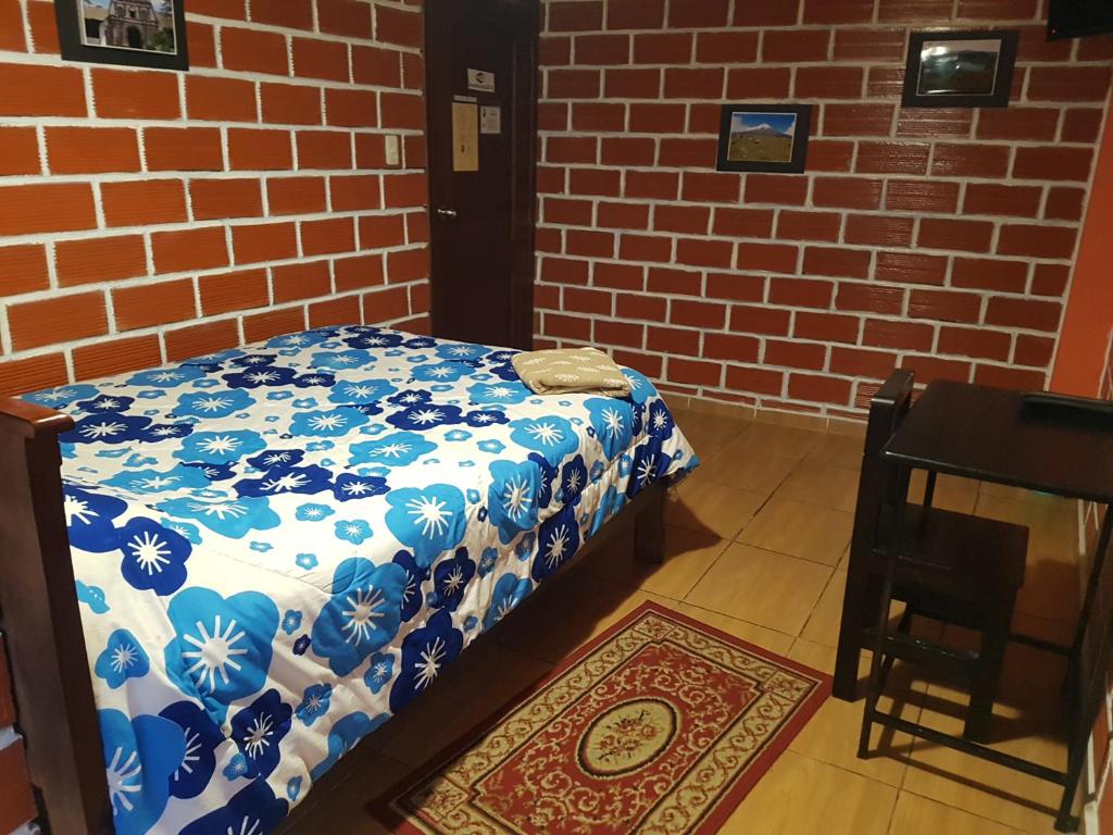 Postel nebo postele na pokoji v ubytování Hostal Sendero de Volcanes