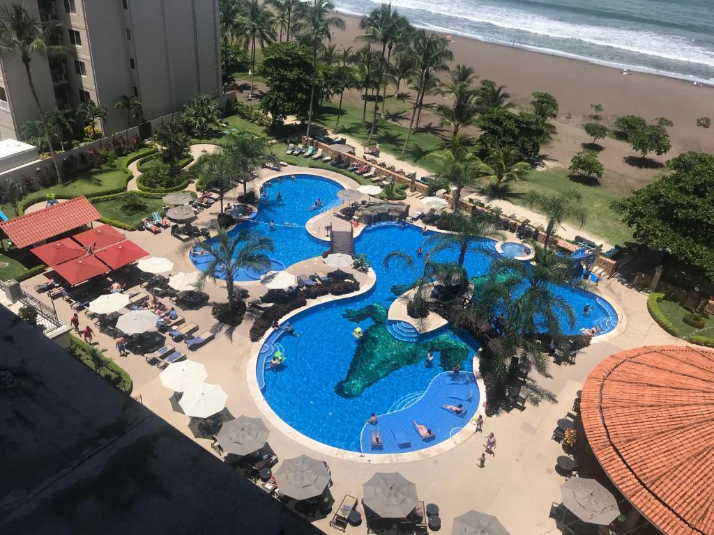 an overhead view of the pool at the resort at Jaco Oceanfront Condo #1119 in a Luxury Resort in Jacó