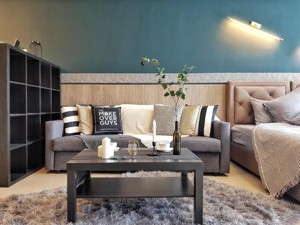 a living room with a couch and a coffee table at SS15 Courtyard Subang Jaya by IdealHub in Subang Jaya