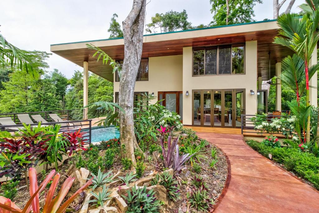 a house with a garden and a pool at Casa Vista Verde in Uvita