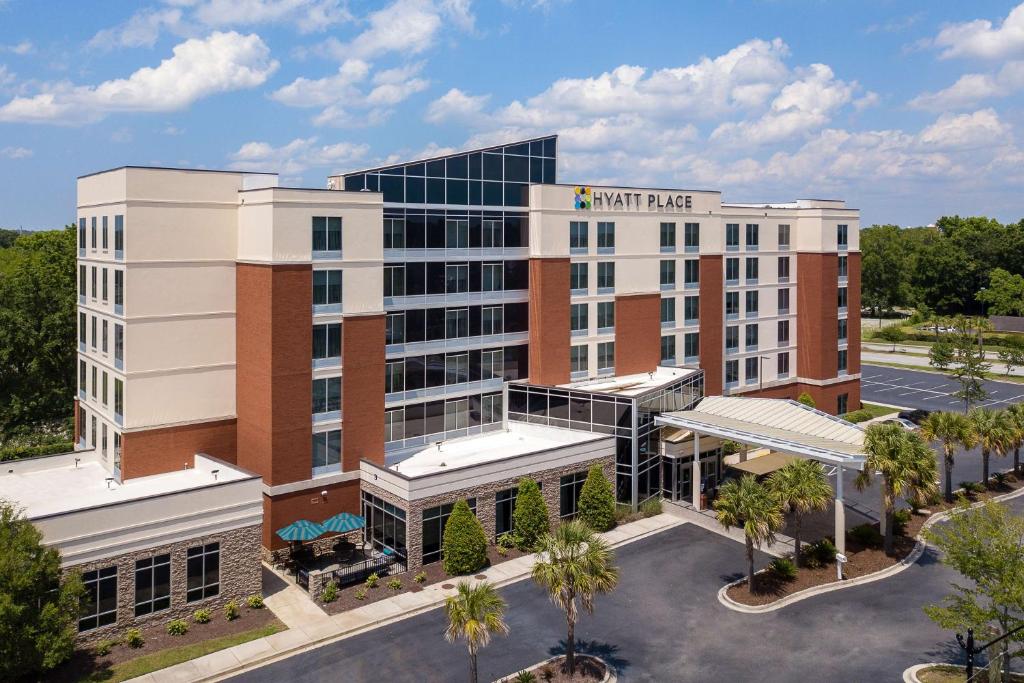 a large building with a lot of windows at Hyatt Place Charleston Airport / Convention Center in Charleston