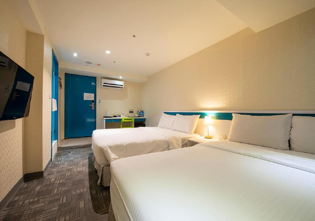 Postel nebo postele na pokoji v ubytování Lumos Inn 拾光行旅