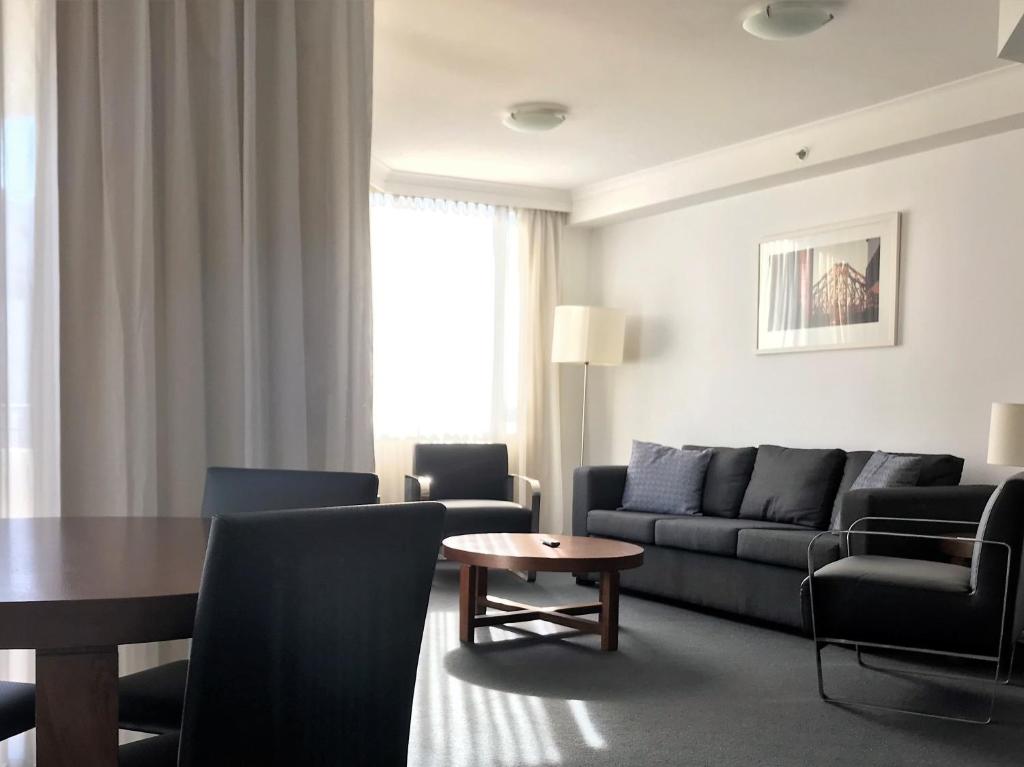 a living room with a couch and a table at Brisbane City Apartments (Albert St CBD) in Brisbane