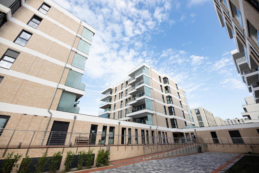 twee hoge gebouwen staan naast elkaar bij Attraktive Apartments im "Port Marina" in Bremerhaven