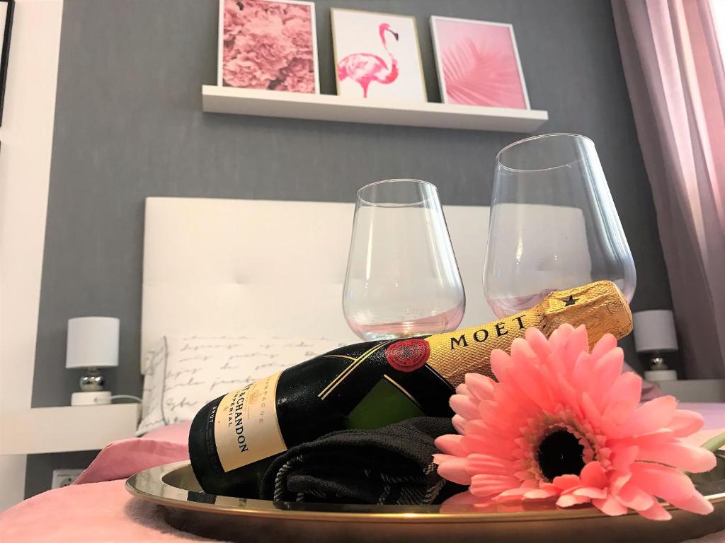 a tray with two wine glasses and a flower on a bed at Estudio Alicante Centro in Alicante