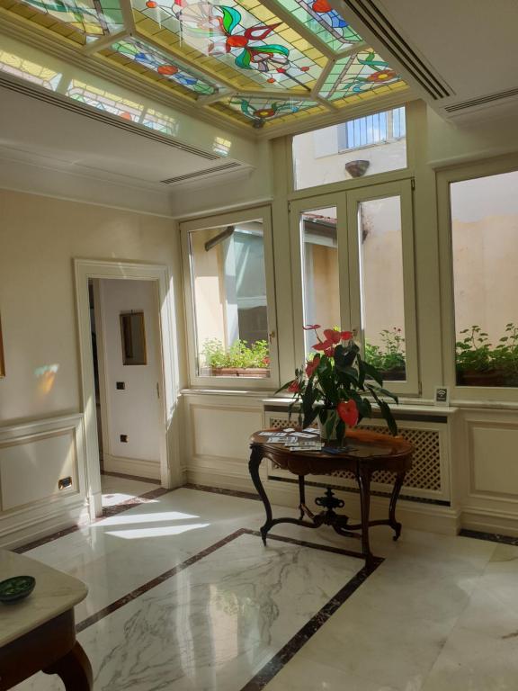 a room with a table and a stained glass ceiling at Al centro Luxury Home in Caserta