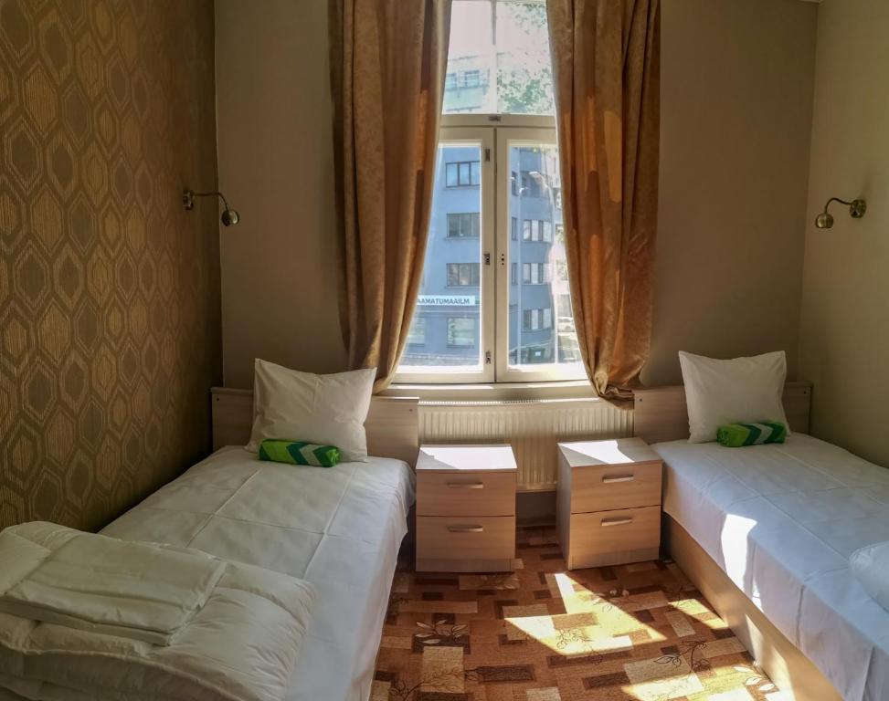 Postel nebo postele na pokoji v ubytování Villa Kadriorg Hostel
