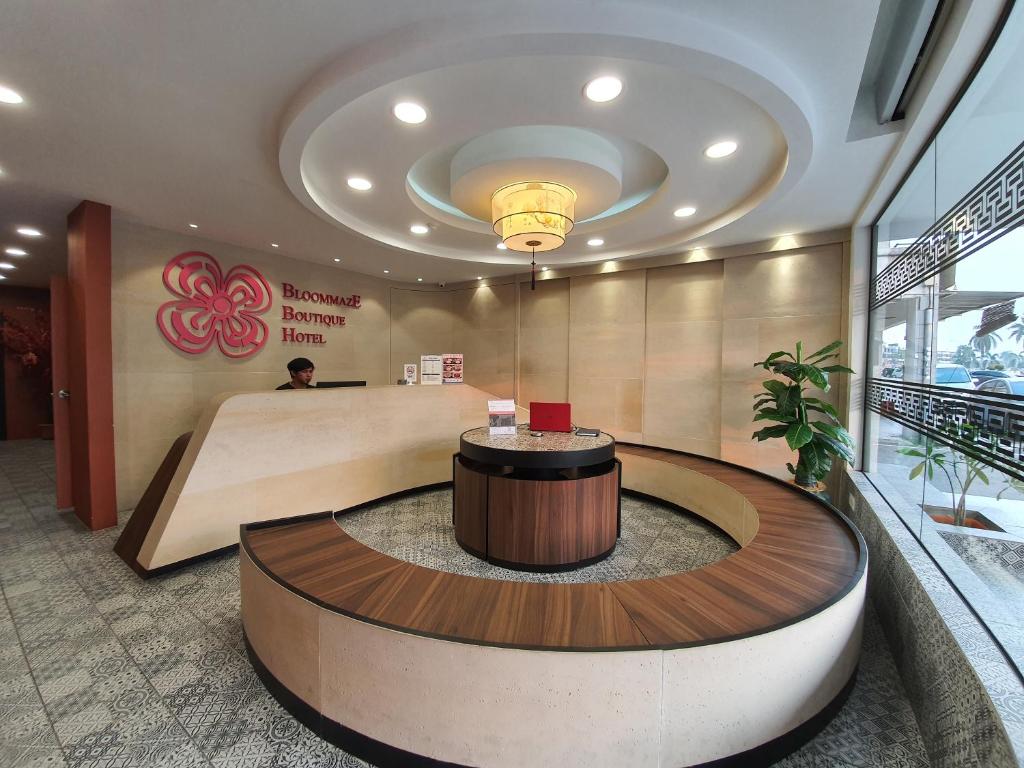 a lobby with a reception desk in a building at Bloommaze Boutique Hotel Klang in Klang