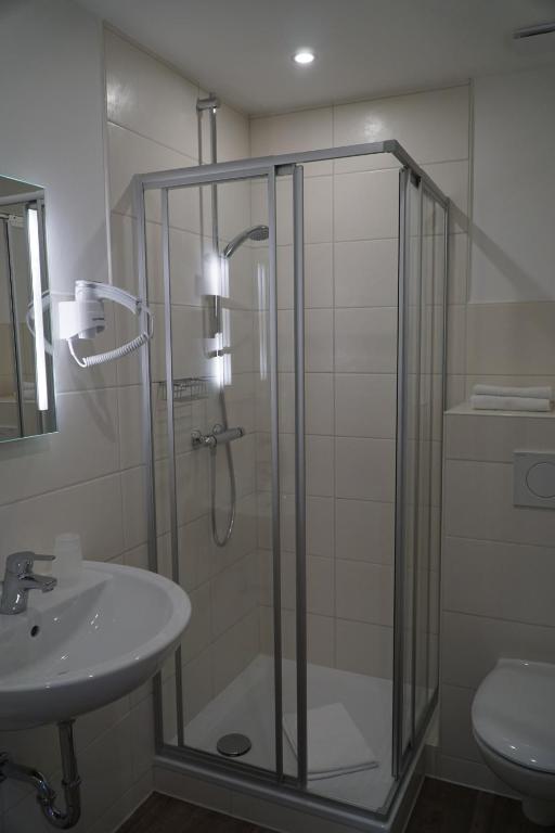 a bathroom with a glass shower and a sink at Mansion in Bad Arolsen