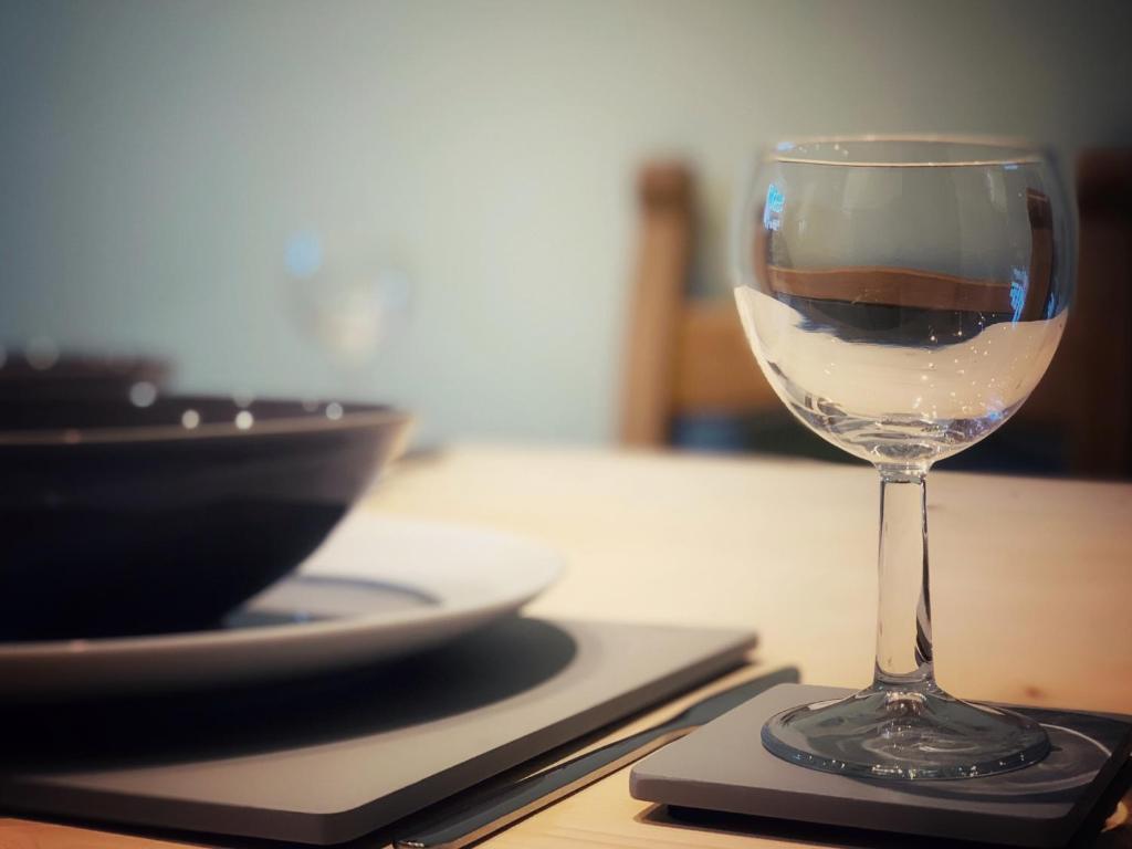 a glass of wine sitting on top of a table at Paul's Place near Heathrow in London