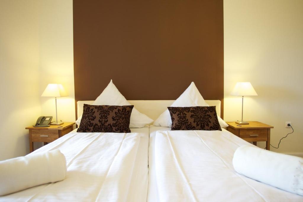 Postel nebo postele na pokoji v ubytování Das Frühstückshotel Sankt Peter-Ording
