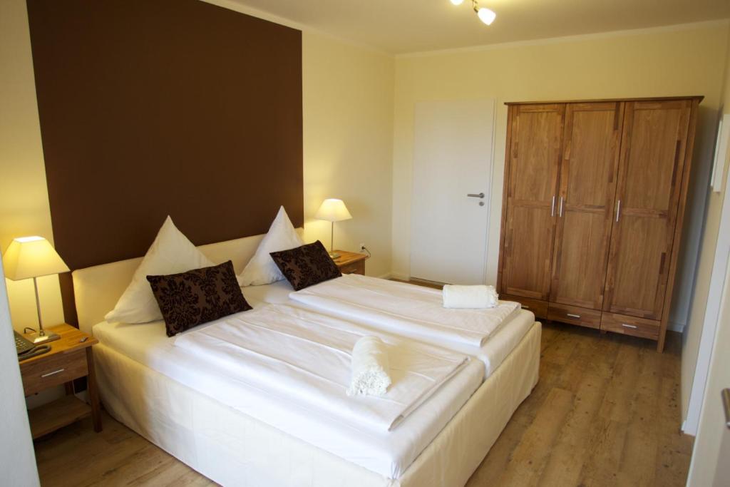 Postel nebo postele na pokoji v ubytování Das Frühstückshotel Sankt Peter-Ording