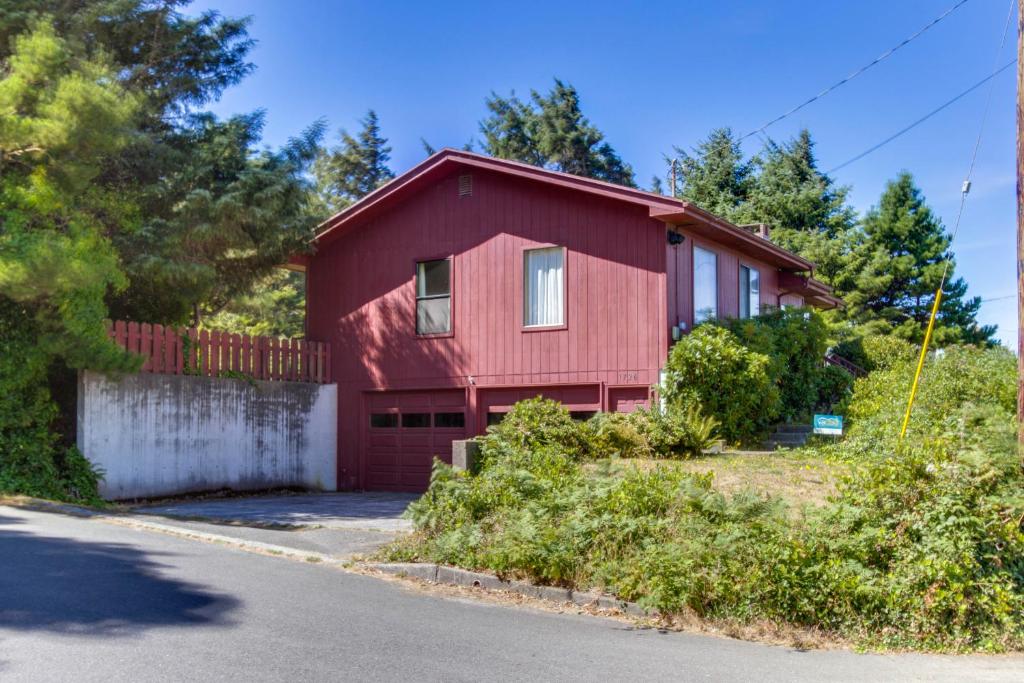 a red house with a garage at The Eagle's Nest in Lincoln City