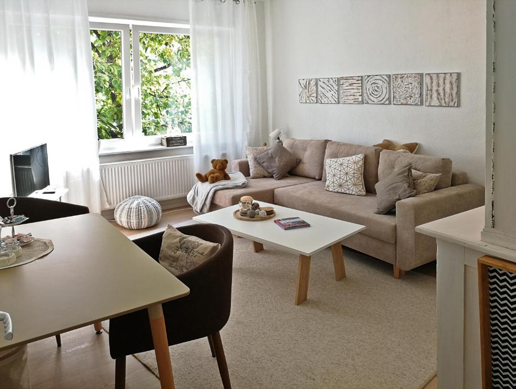 a living room with a couch and a table at Christels Gästewohnung in Bünde