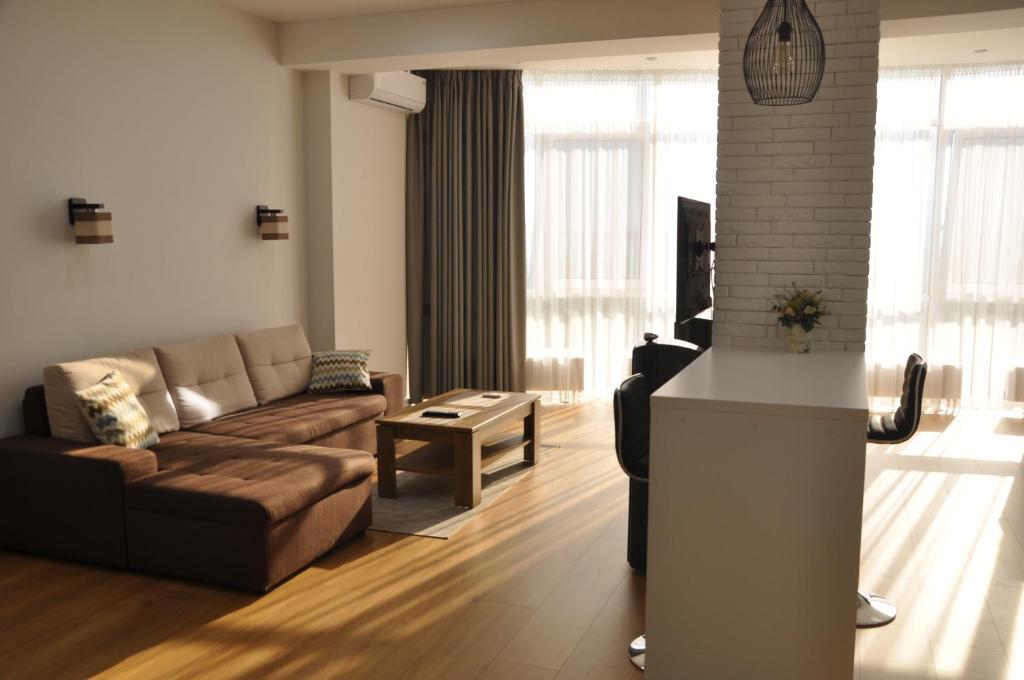 a living room with a couch and a table at Sky Apartment in Odesa