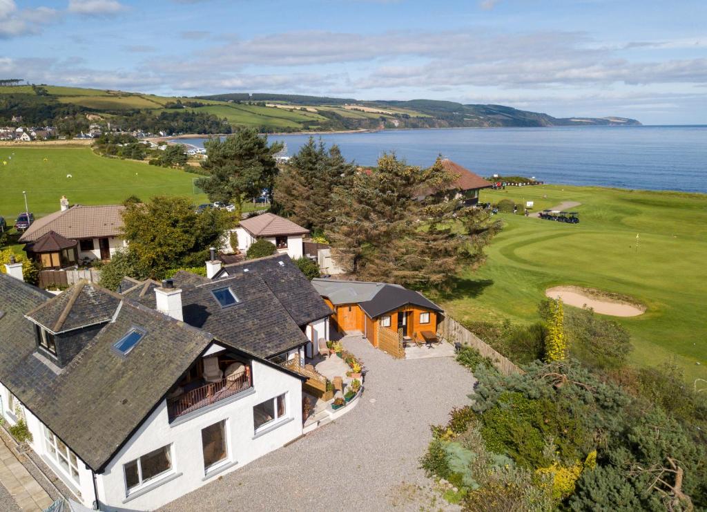 an aerial view of a house with the ocean in the background at The Mended Drum in Fortrose