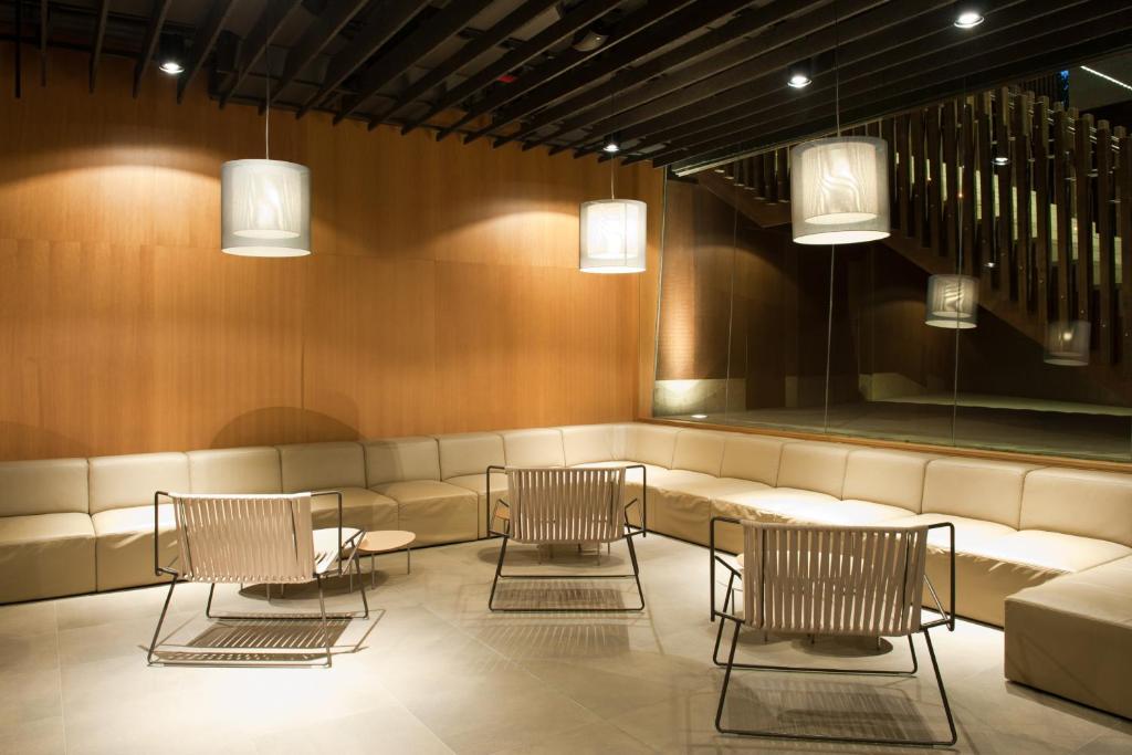 a waiting room with chairs and a couch at Sotavento Beach Club in Costa Calma
