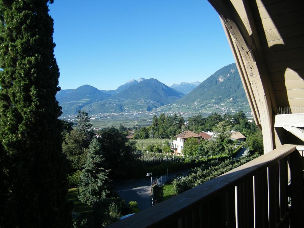 a view of the mountains from the balcony of a house at Hotel Angelica in Merano